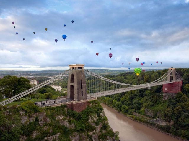 Bristol's Clifton Suspension Bridge is surrounded in the sky by colourful hot air-balloons